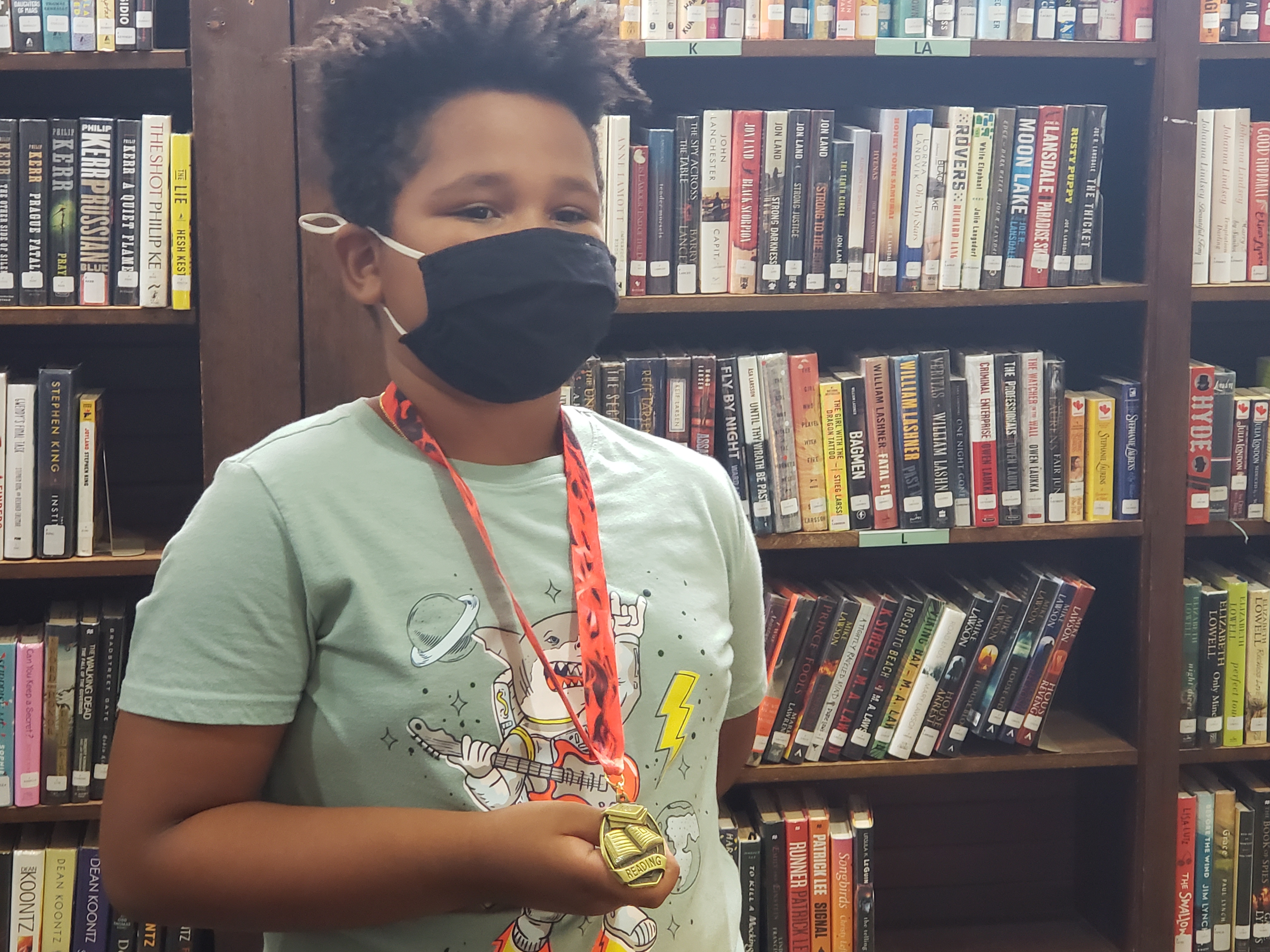 Young reader MASON with his Summer Reading medal 