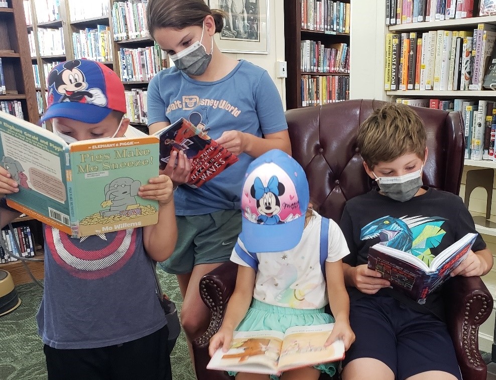 kids enjoy reading at library