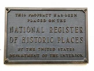 A plaque designating that "This property has been placed on the National Register of Historic Places by the US Dept. of the Interior"